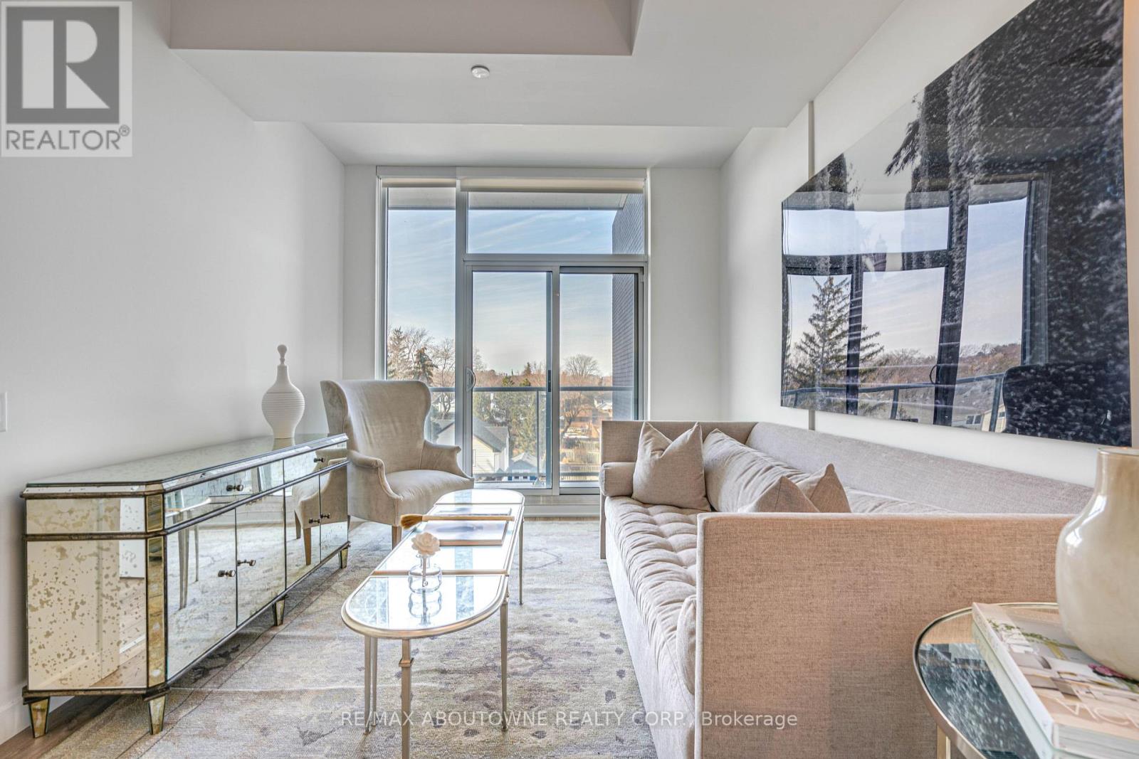 A living room with a glass table and a couch.