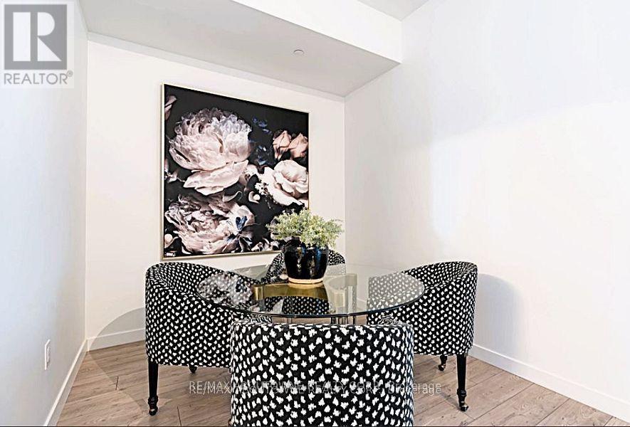 A dining room with a black and white table set.
