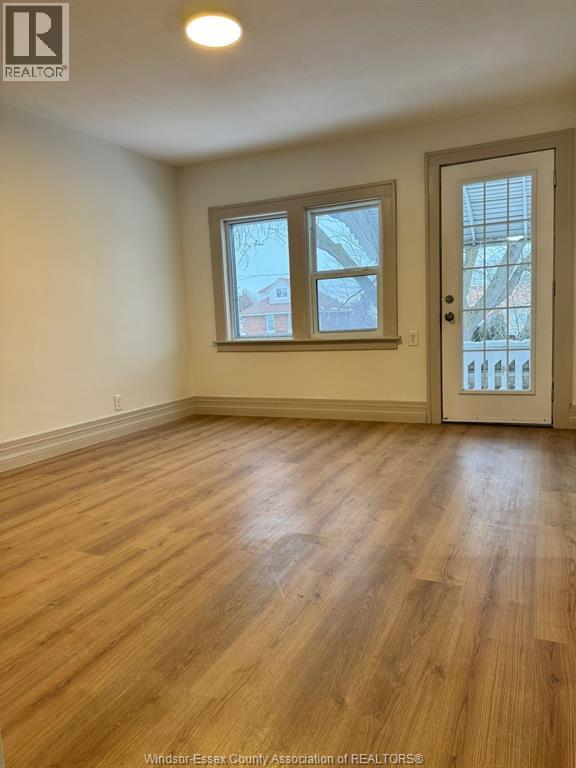 A room with wooden floors and a white door.