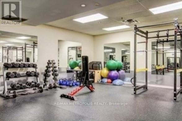 A gym with a variety of equipment including dumbbells, weight plates, and resistance bands.