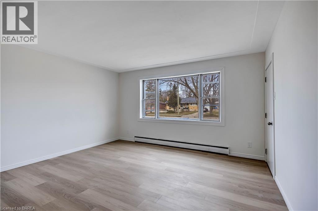 A room with a window and a picture on the wall.