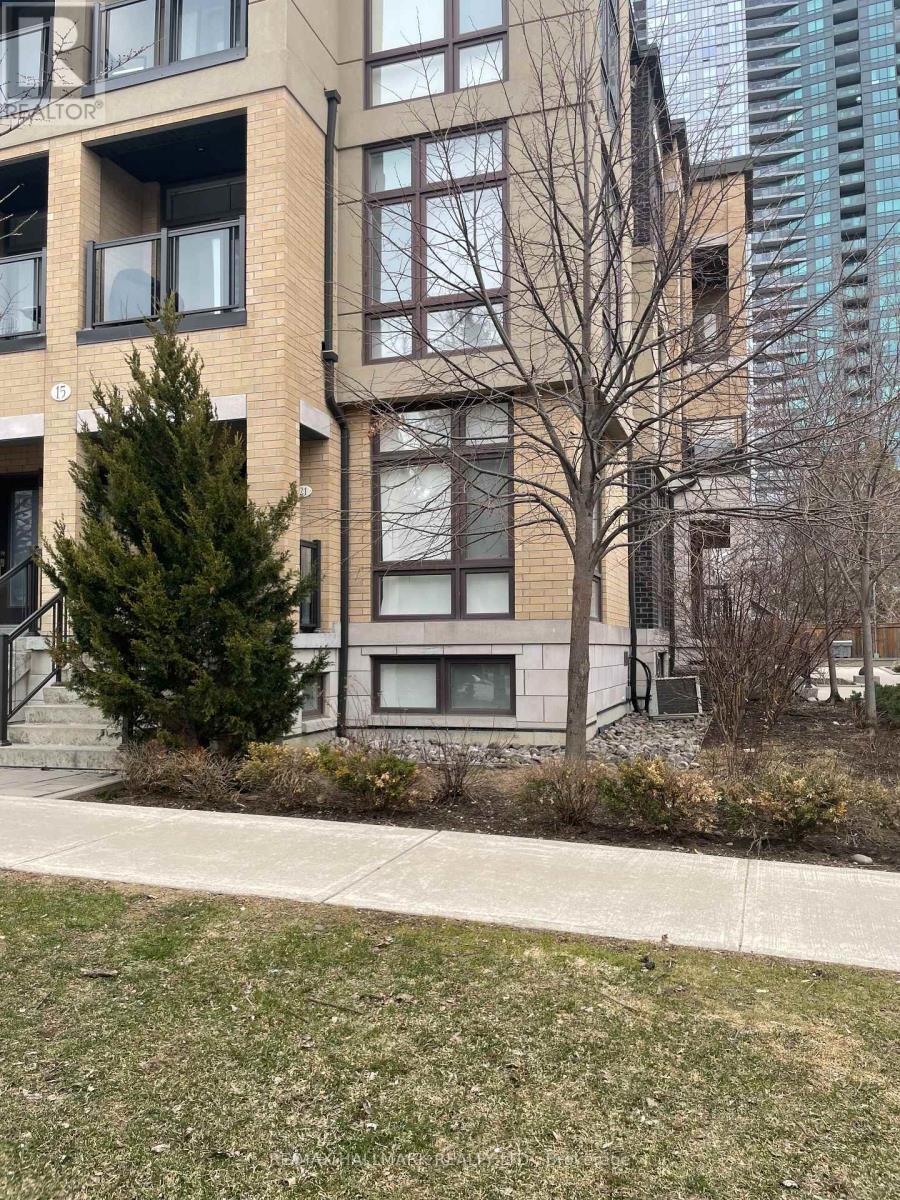 A brown building with a tree in front of it.