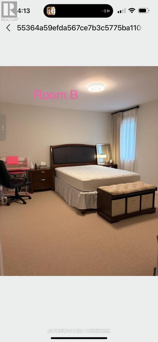 A bedroom with a bed, nightstand, and chair.