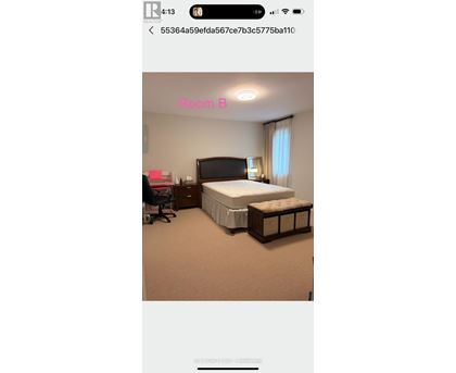 A bedroom with a bed, nightstand, and chair.