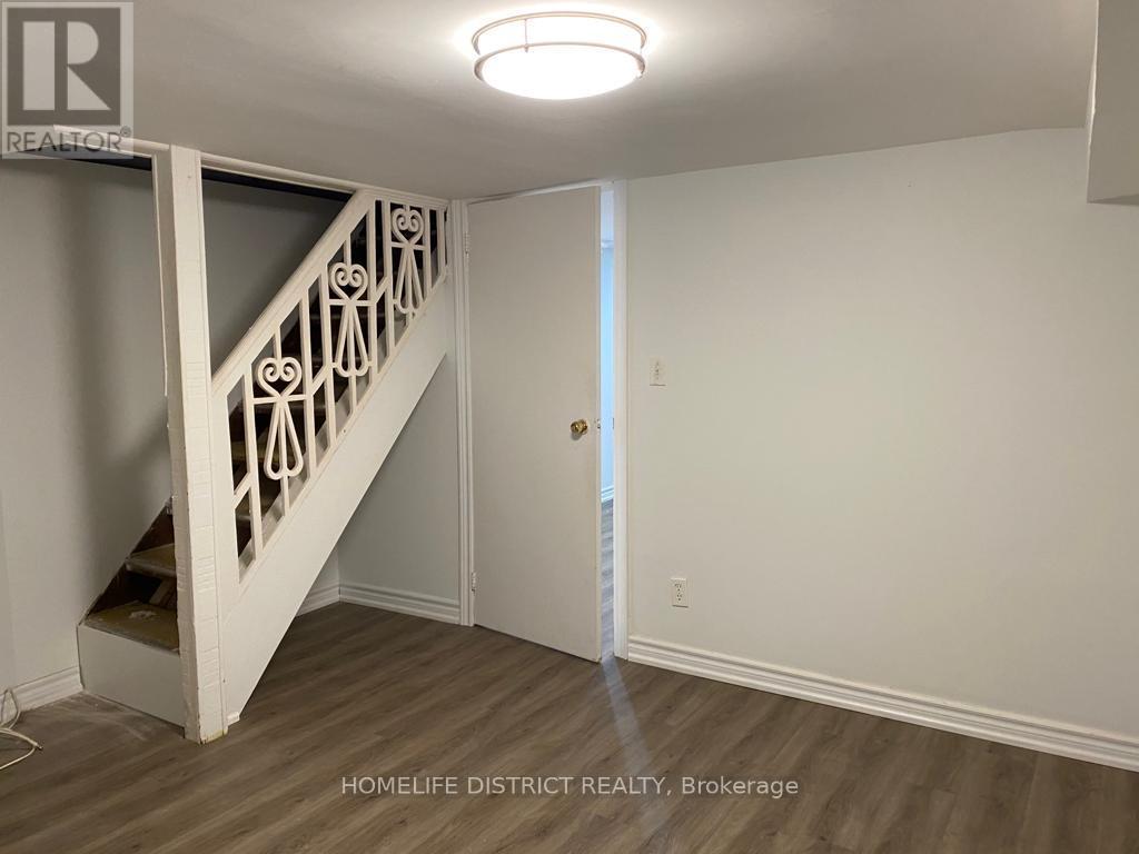 A white staircase with a light on the ceiling.