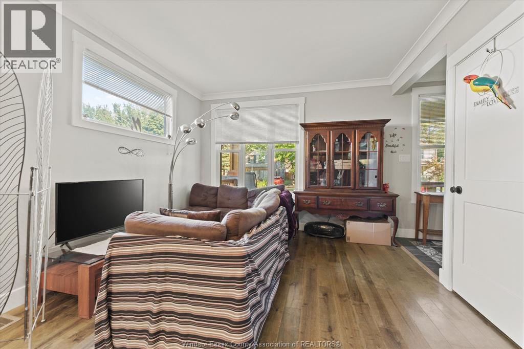 A living room with a striped sofa and a television.