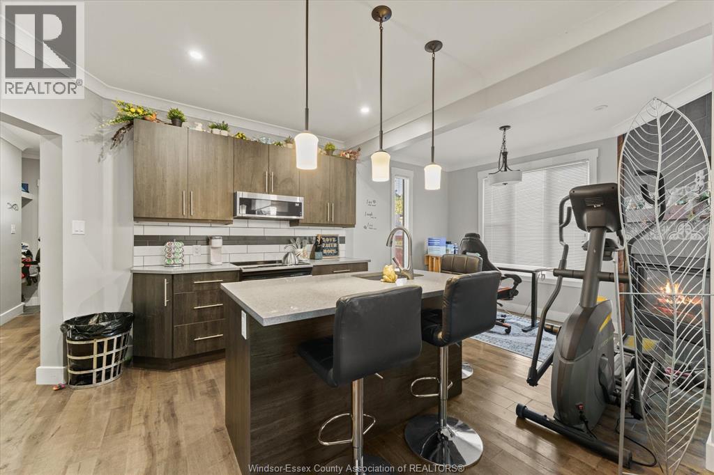 A well-lit kitchen with a dining table and chairs.