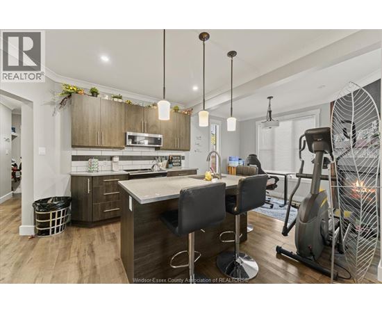 A well-lit kitchen with a dining table and chairs.