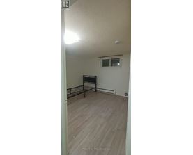 A bedroom with a bed and a window.
