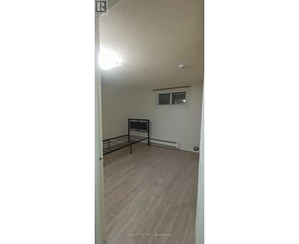 A bedroom with a bed and a window.