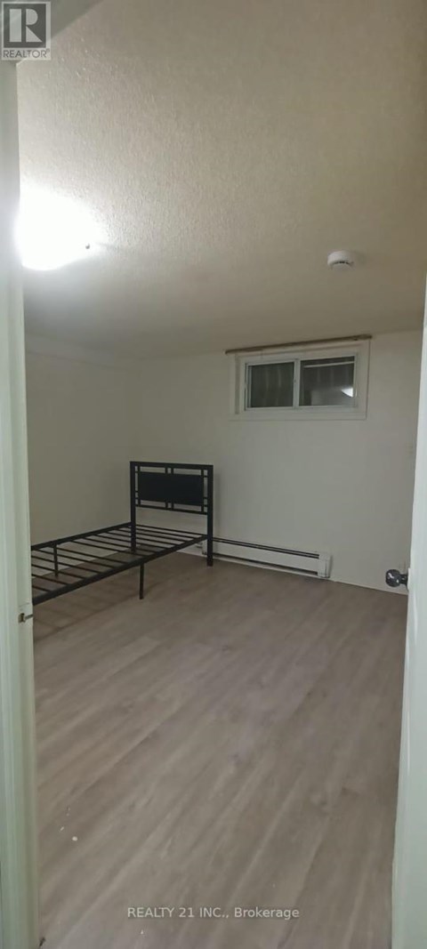 A bedroom with a bed and a window.