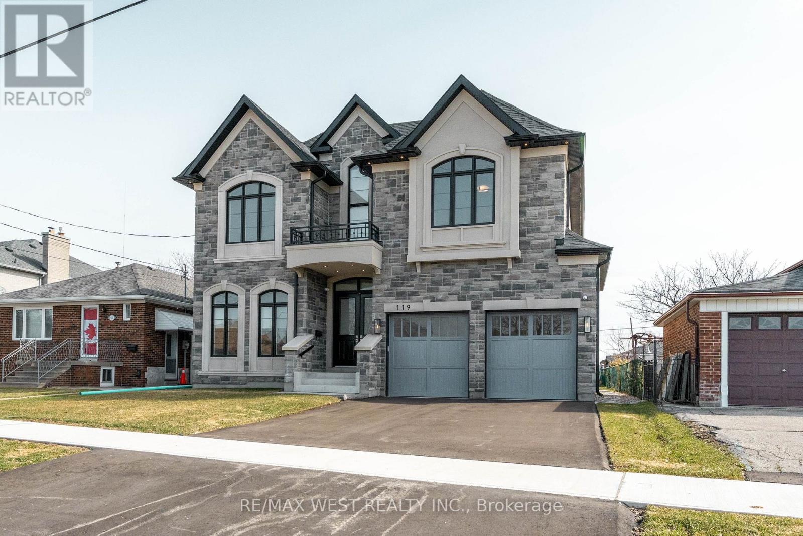 A large, two-story house with a garage is for sale.