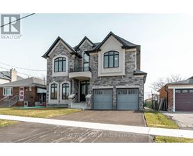 A large, two-story house with a garage is for sale.