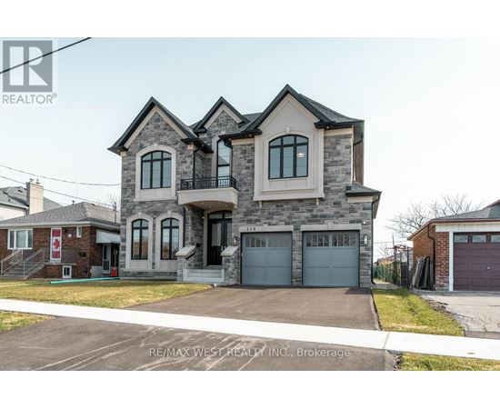 A large, two-story house with a garage is for sale.
