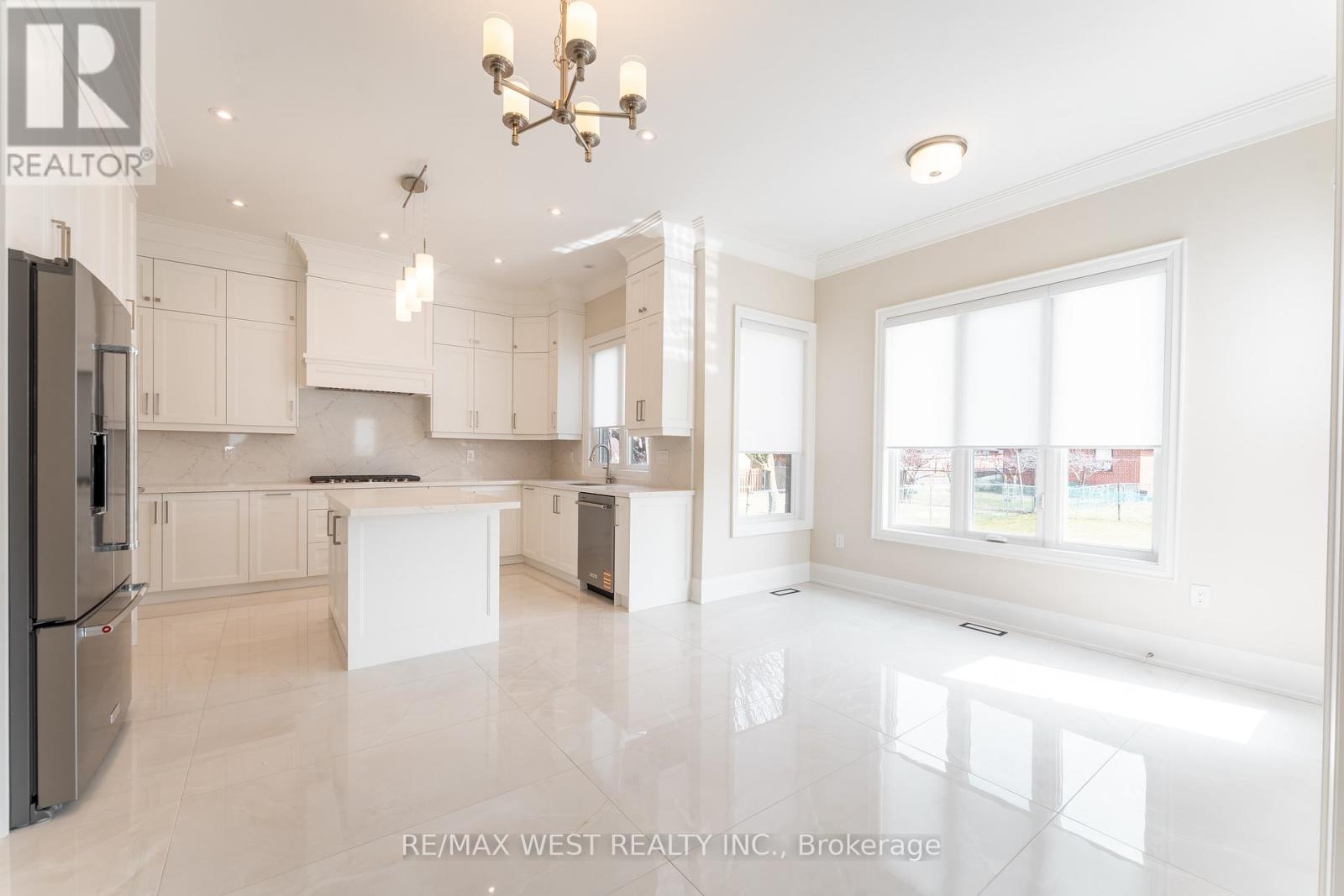 A spacious kitchen with white cabinets and a large island.