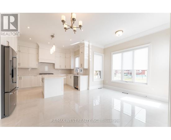 A spacious kitchen with white cabinets and a large island.