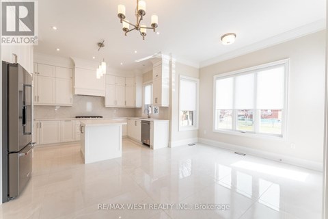 A spacious kitchen with white cabinets and a large island.