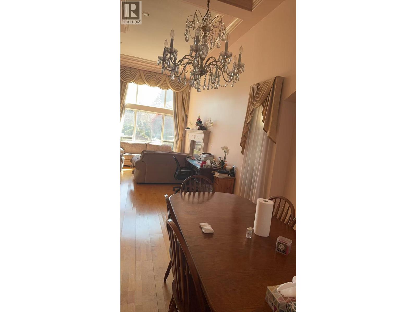 A dining room with a wooden table and chairs.