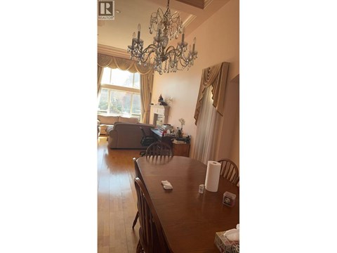 A dining room with a wooden table and chairs.