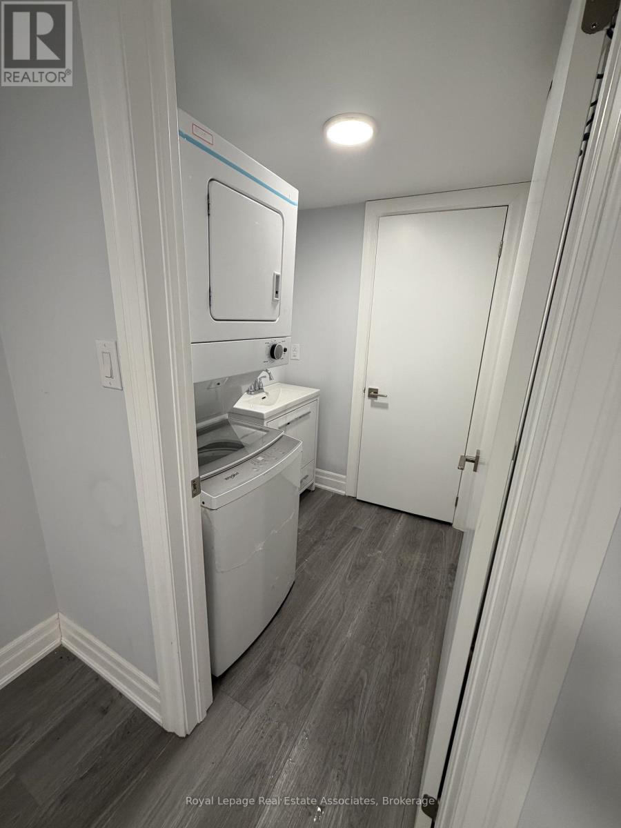 A white bathroom with a toilet and sink.