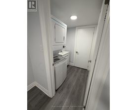 A white bathroom with a toilet and sink.