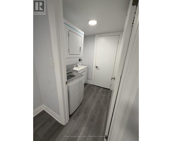 A white bathroom with a toilet and sink.