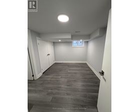 A room with a grey floor and white walls.
