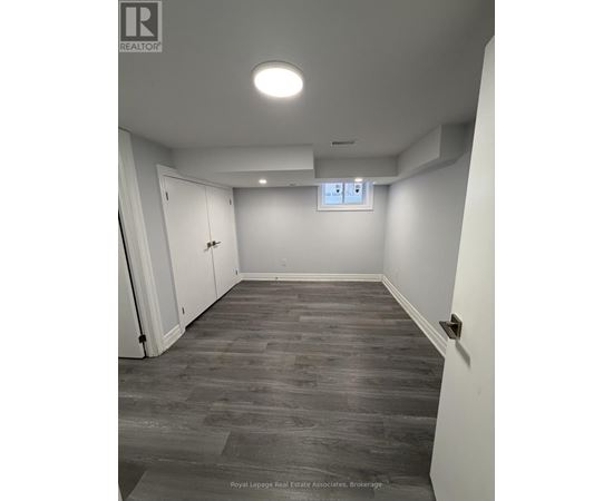 A room with a grey floor and white walls.