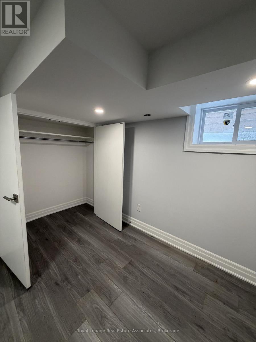 A room with a wooden floor and a window.