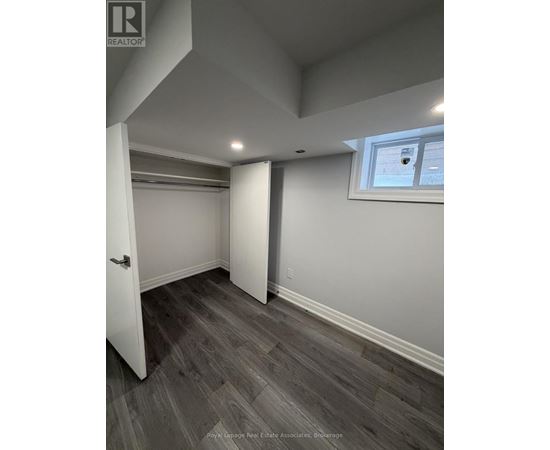A room with a wooden floor and a window.