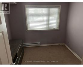 A room with a window and a radiator on the floor.