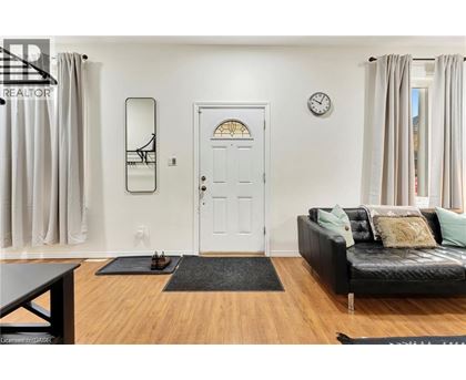 A living room with a black couch and a white door.