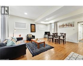 A living room with a black couch and a wooden coffee table.