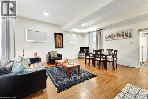 A living room with a black couch and a wooden coffee table.