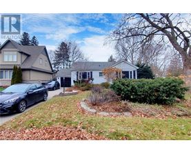 A realtor logo is superimposed on a photo of a house with a car parked in front.