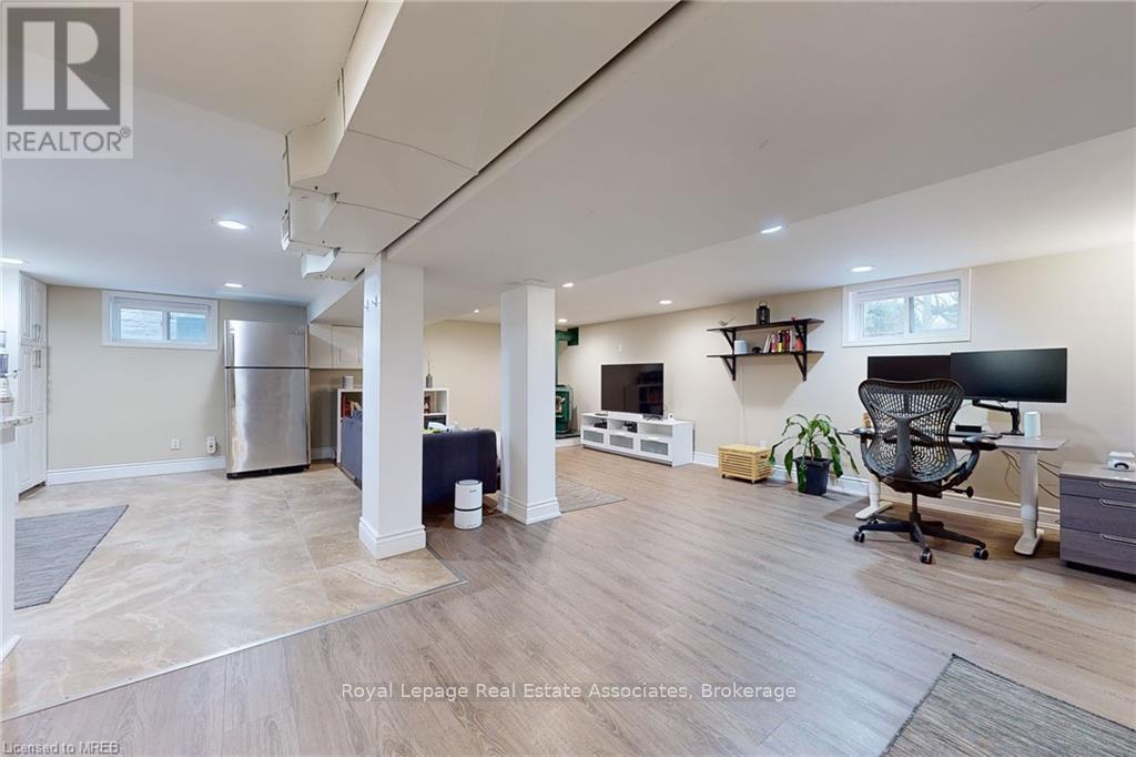 A spacious room with a desk and a chair in it.