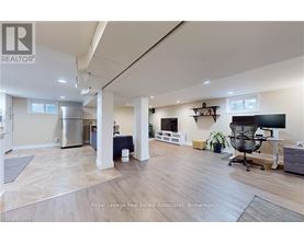 A spacious room with a desk and a chair in it.