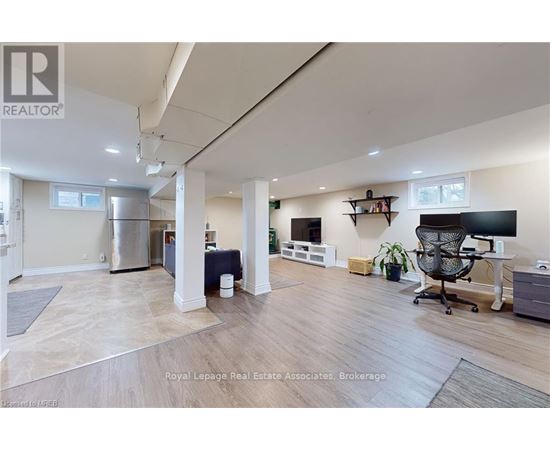 A spacious room with a desk and a chair in it.