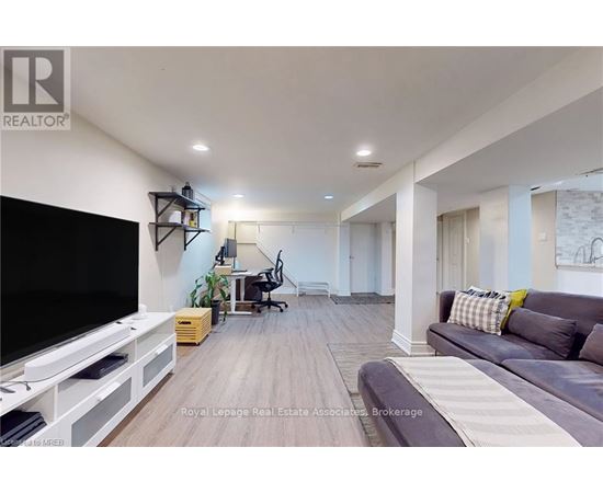 A living room with a grey couch and a television.