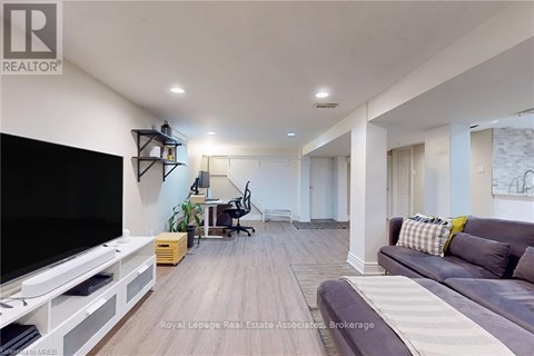 A living room with a grey couch and a television.
