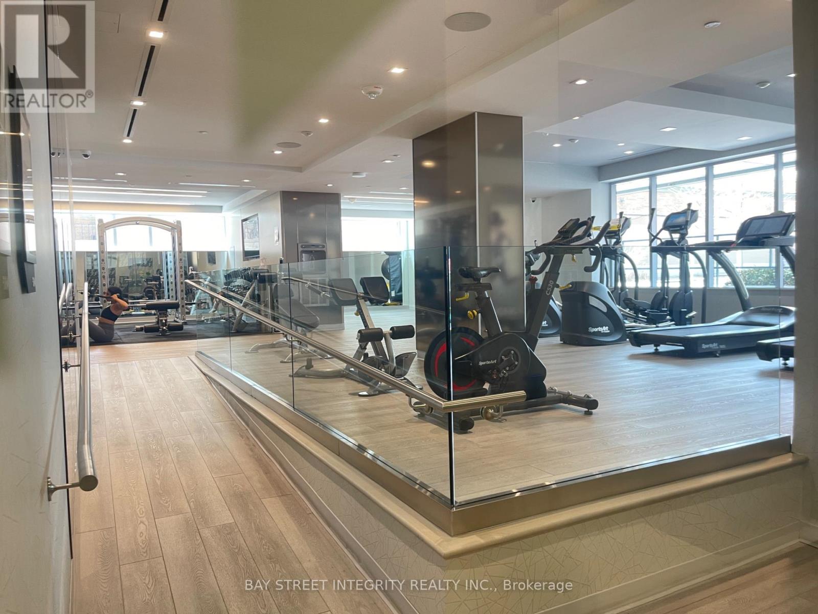 A gym with treadmills, elliptical machines, and other exercise equipment.