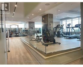 A gym with treadmills, elliptical machines, and other exercise equipment.