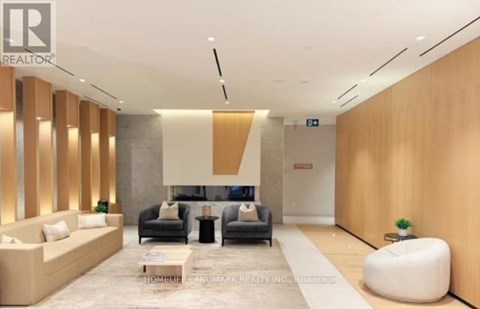 A modern living room with a grey sofa set and wooden accents.