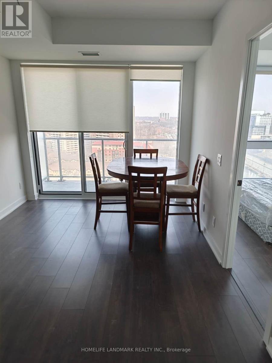 A dining room with a table and chairs and a view of the city.