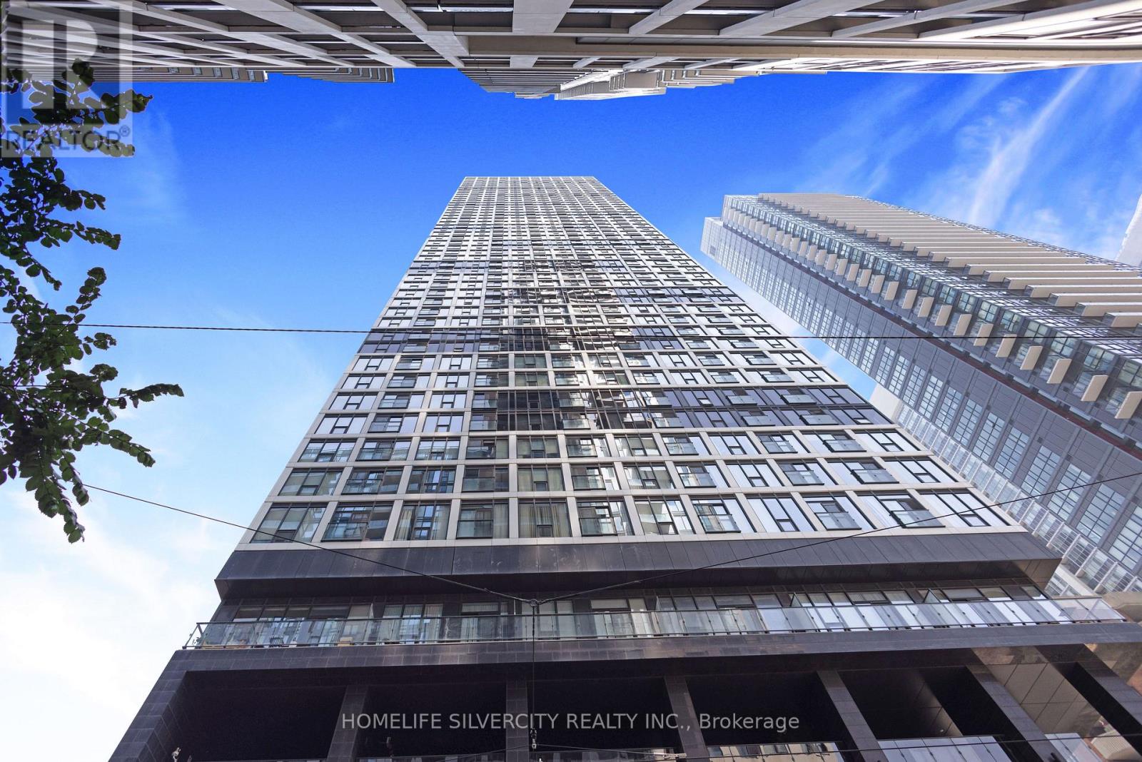 A tall building with the words "Homelife Silvercity Realty Inc. Brokerage" on its facade.