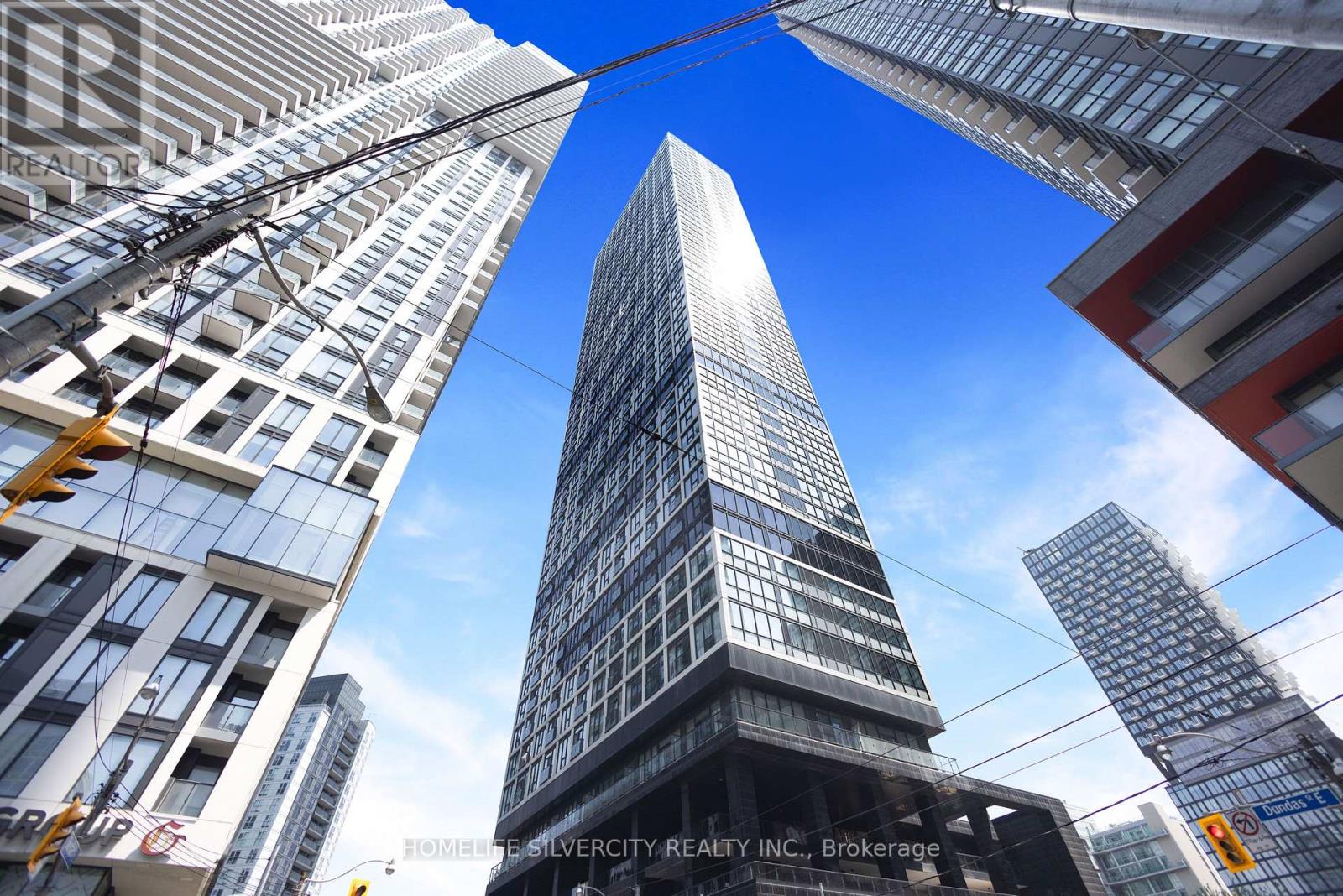 A tall skyscraper stands in the middle of a cityscape.