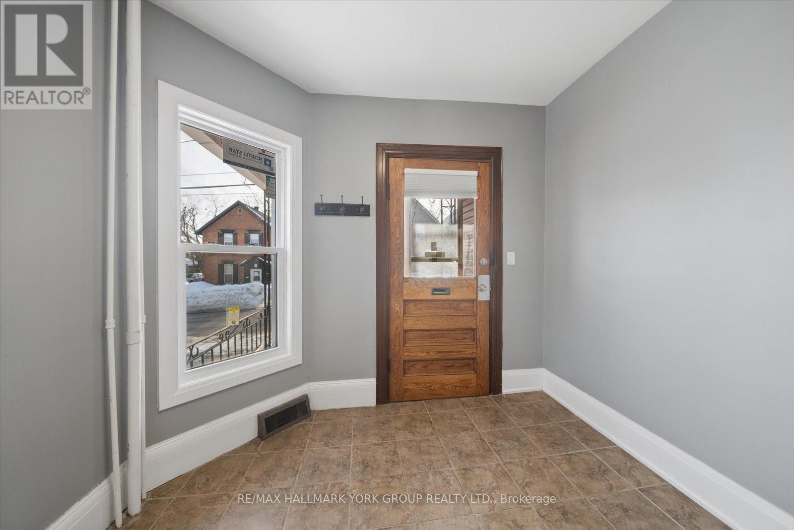 A room with a door and a window showing a snowy scene outside.