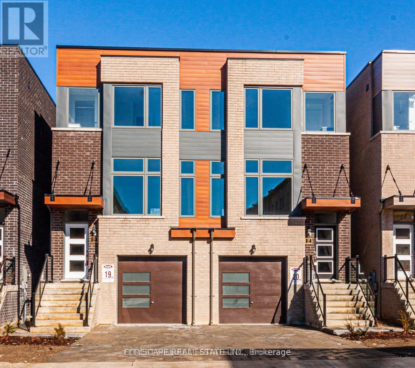 A modern two-story building with a mix of brick and wood paneling.