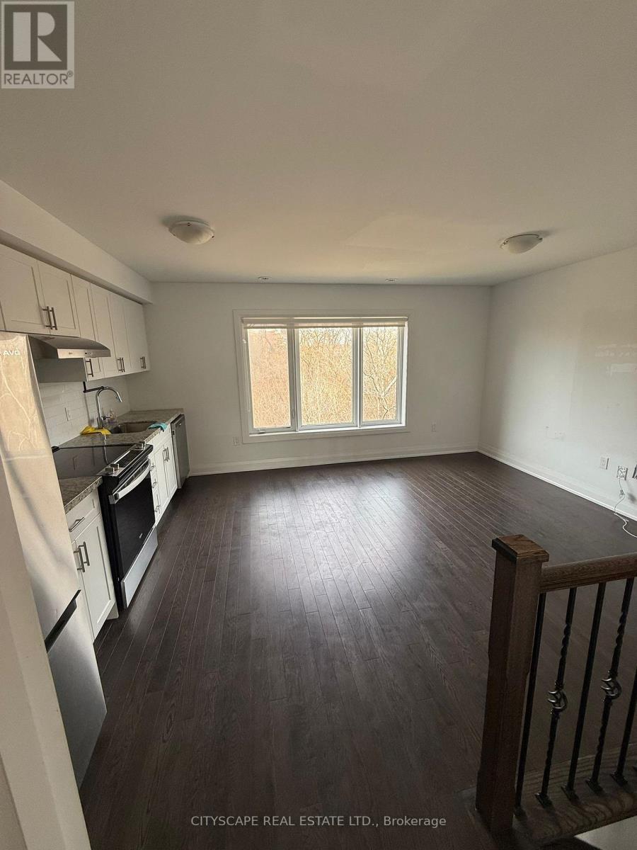 A kitchen with white appliances and wooden floors.