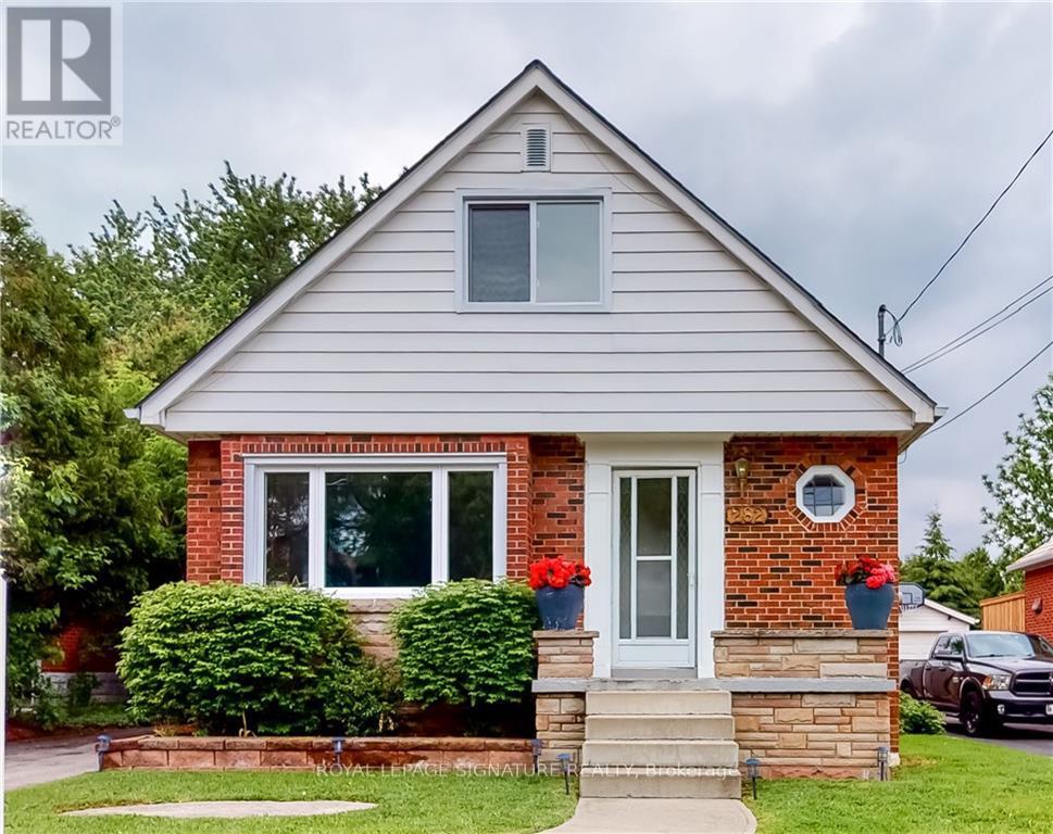 A house with a grey roof and a white door is for sale.